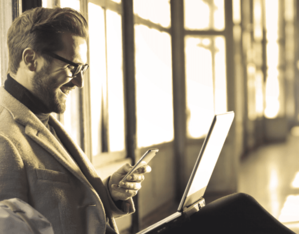 Businessman working with his laptop and mobile phone