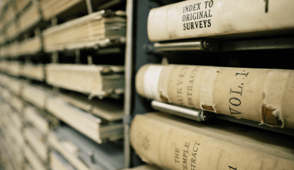 Stack of old survey books on a shelf